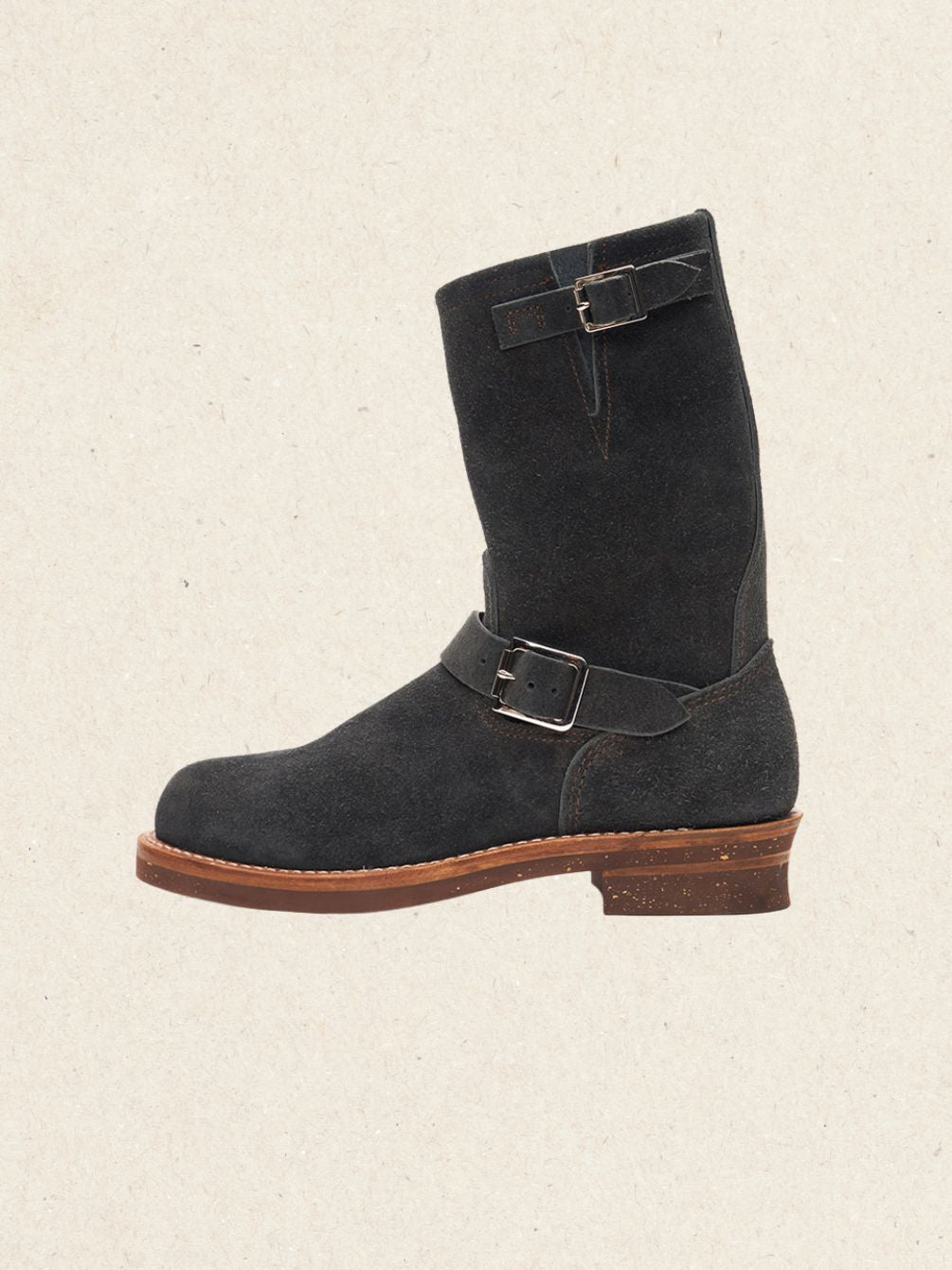 Pair of black suede engineer boots with twin buckle straps on a brown welted sole