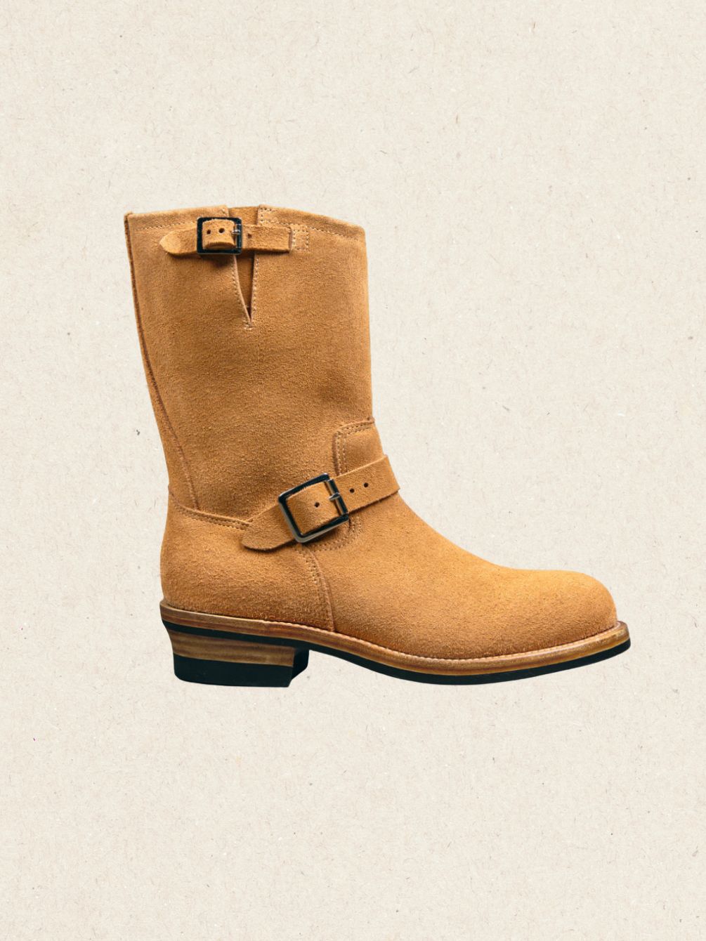 Pair of brown roughout suede engineer work boots shown at an angle, twin buckle straps and stacked heel