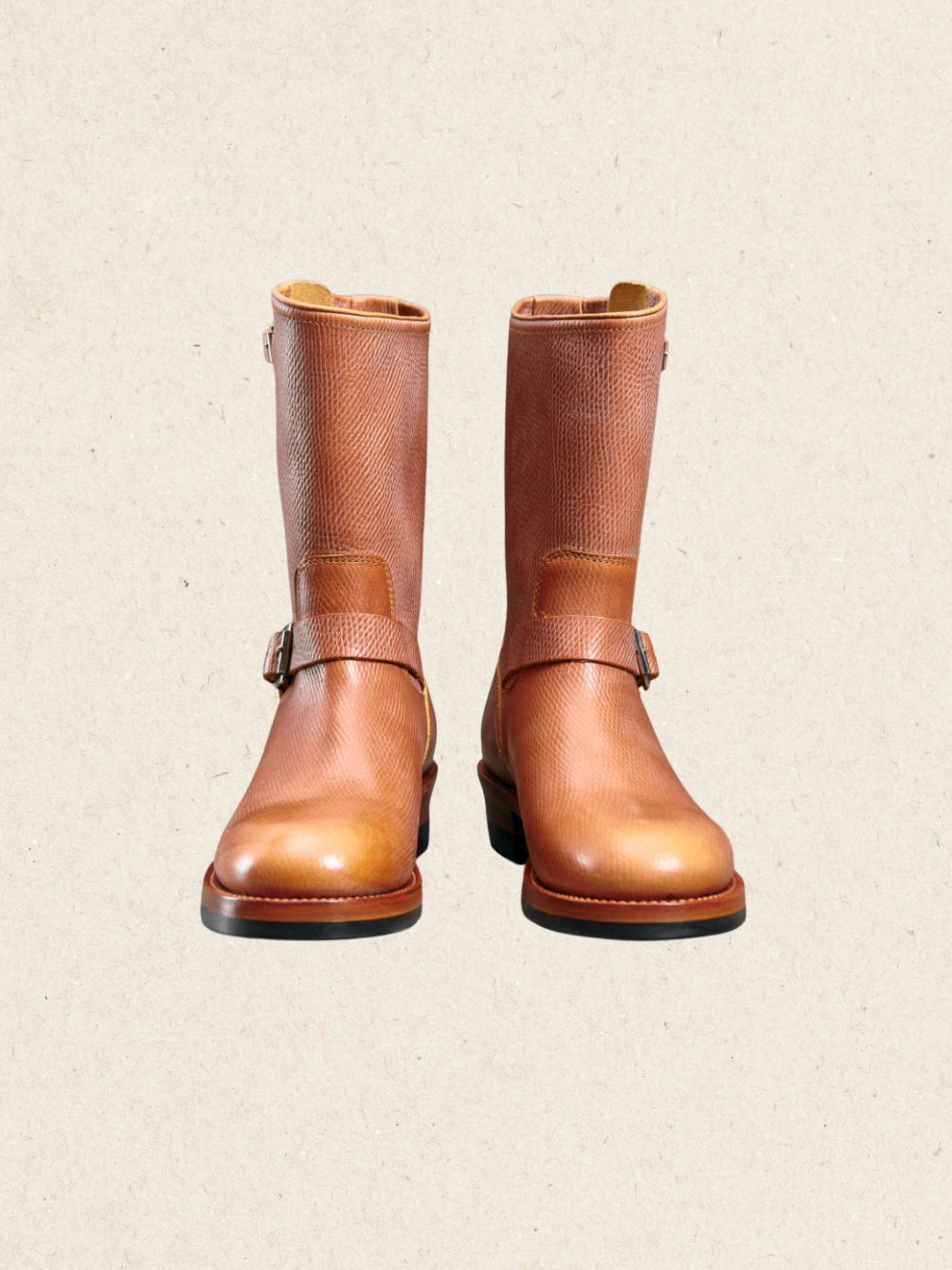 Pair of brown textured leather engineer boots in hand-embossed cowhide with twin buckle straps