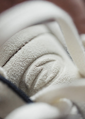 arrow embossed tongue detail on retro running shoes