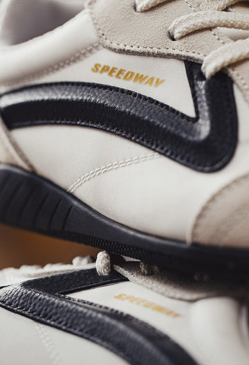 retro running shoes with speedway gold side badge