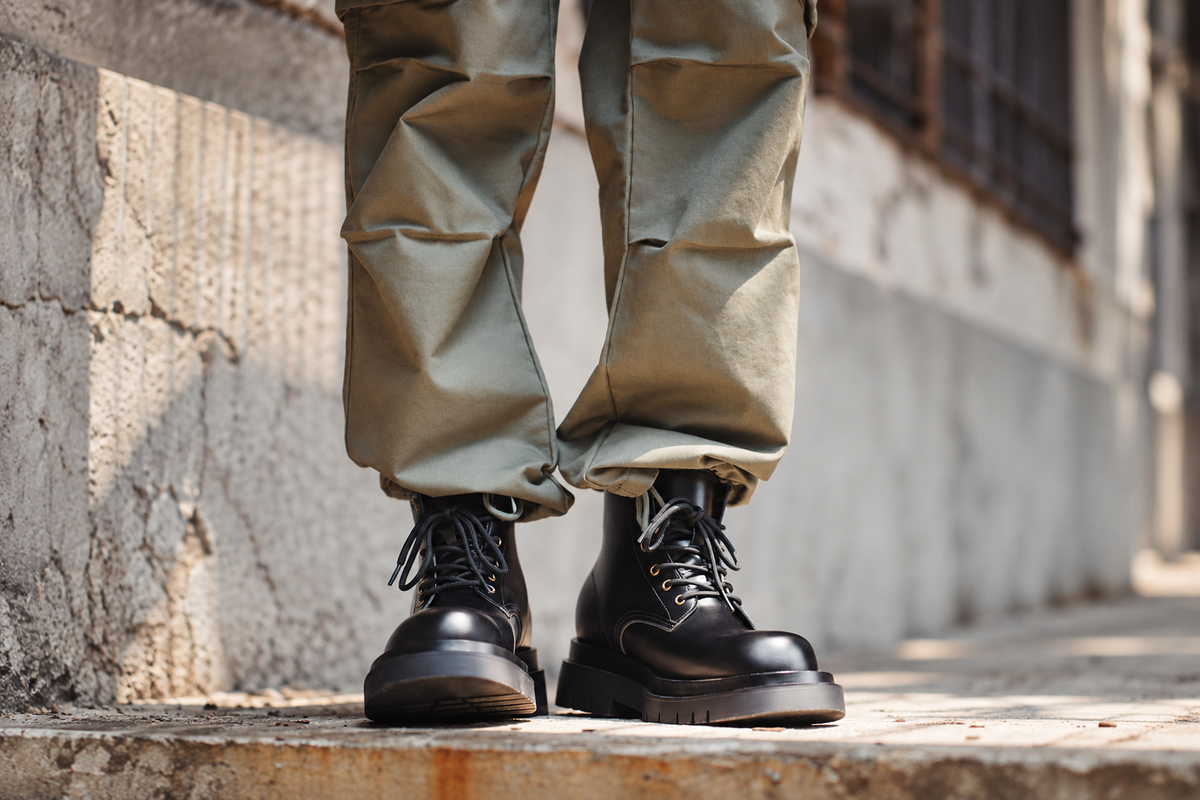 Black Hector Maden leather boots worn with relaxed khaki trousers
