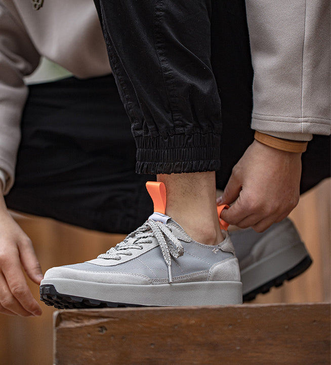 Grey Hector Maden sneakers being laced for everyday wear