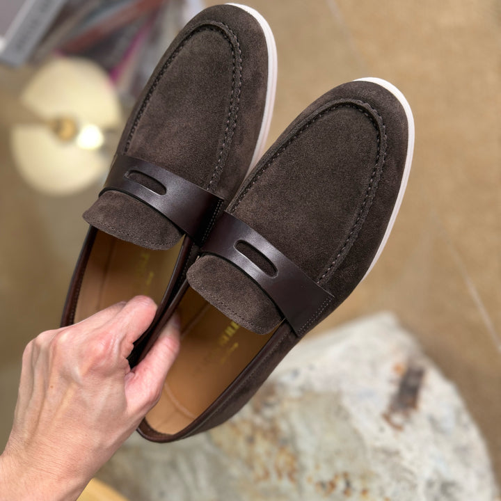 Brown suede Hector Maden loafers held for a close look