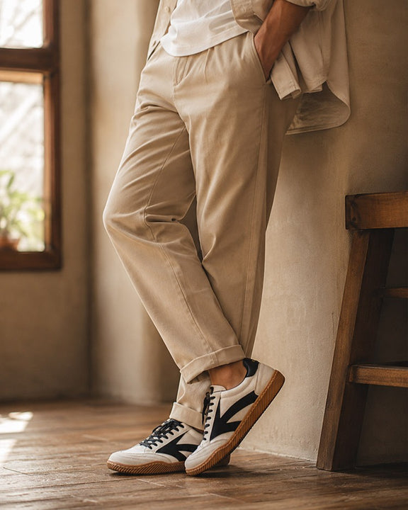 Hector Maden retro sneakers worn indoors with relaxed trousers